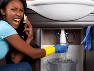 Emergency plumbing repair for a leaking sink drain under a bathroom vanity in Fort Worth, TX