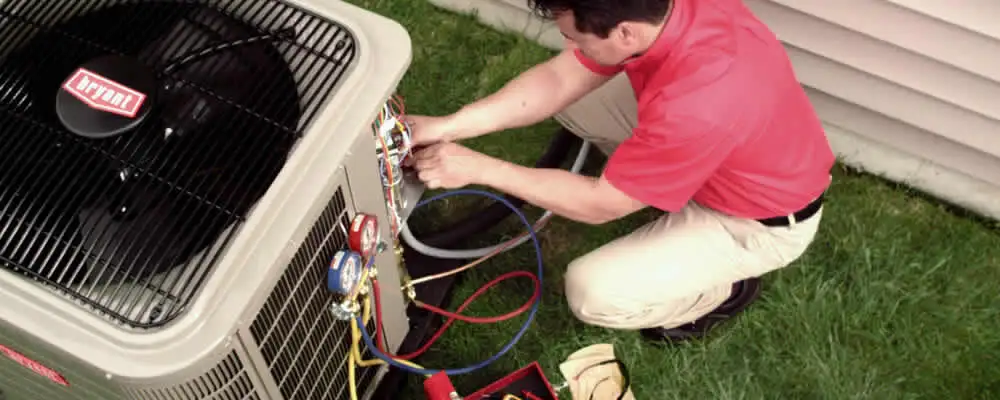 HVAC technician servicing an outdoor air conditioner unit in Fort Worth, TX