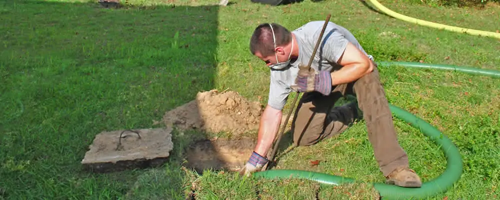 Septic pumping technician servicing a residential septic tank in Fort Worth, TX
