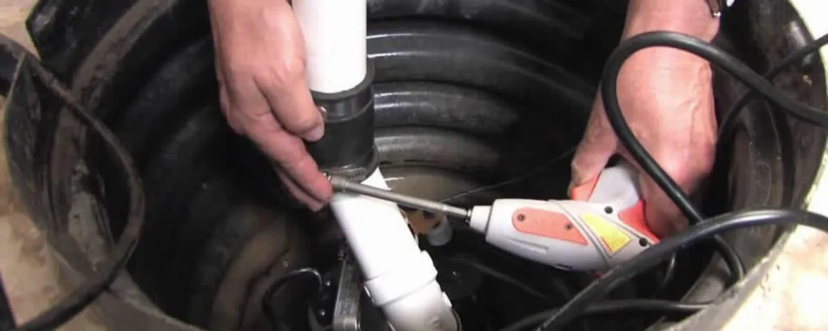 Sump pump installation technician connecting PVC discharge piping in Fort Worth, TX